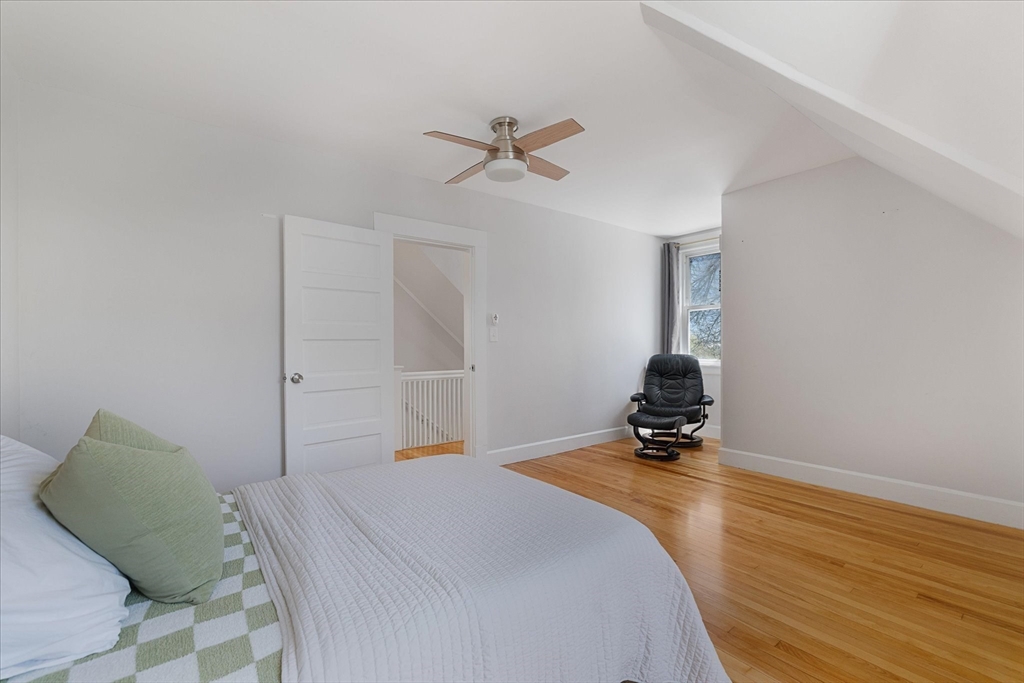4 Chamberlain Parkway Worcester, MA 01602 - Photo 27 of 42 a bedroom with a bed and a chandelier