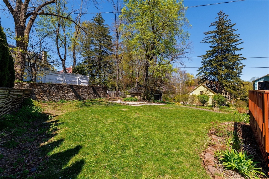 4 Chamberlain Parkway Worcester, MA 01602 - Photo 37 of 42 a view of a backyard with plants and large trees