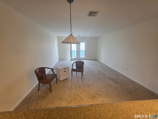a living room with furniture and a ceiling fan