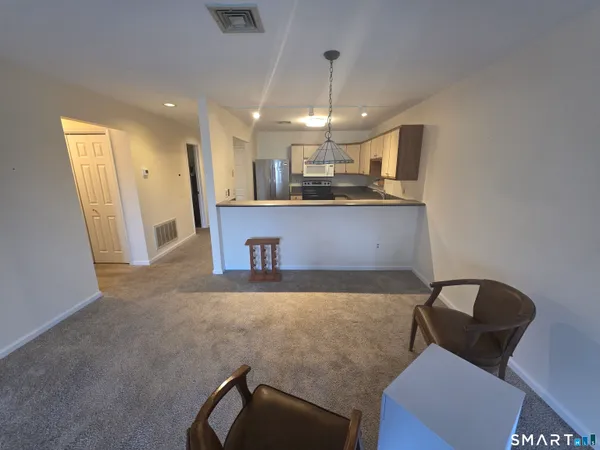 a view of kitchen and dining area with furniture