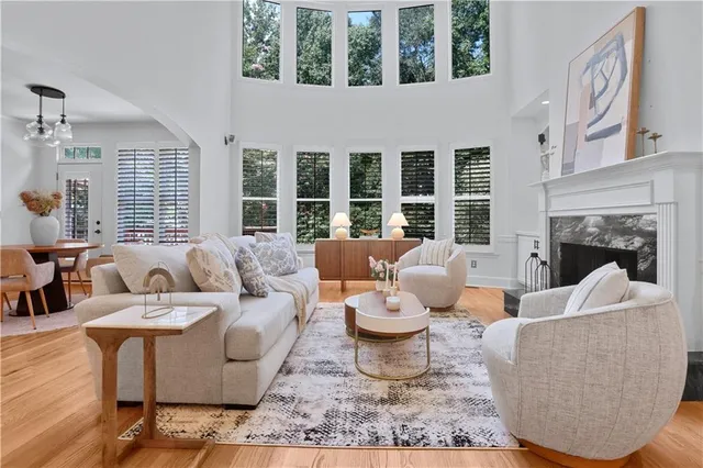 a living room with furniture a window and a fireplace