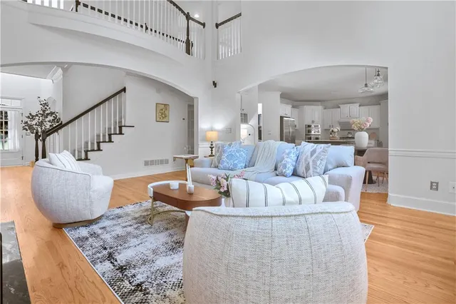 a living room with furniture and a dining table