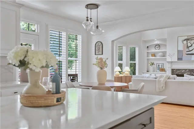 a kitchen with white cabinets and appliances