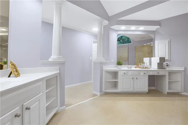 a bathroom with a tub sink and mirror