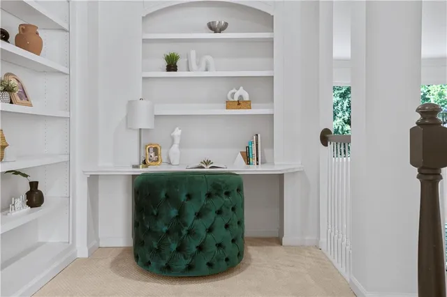 a room with table chairs and window