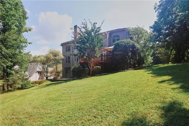 an aerial view of a house with outdoor space
