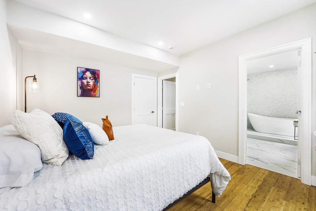 86 Cypress Street, Unit 86 Watertown, MA 02472 - Photo 31 of 38 a bedroom with a bed and a view of bathroom