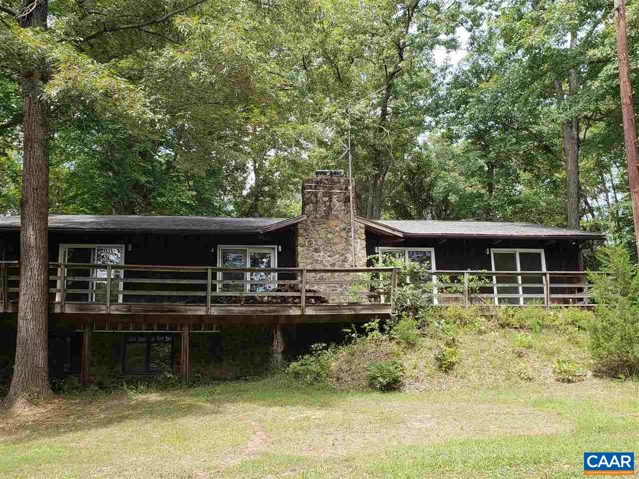 680 Campbell Road Keswick, VA 22947 - Photo 1 of 19 a backyard of a house with yard table and chairs