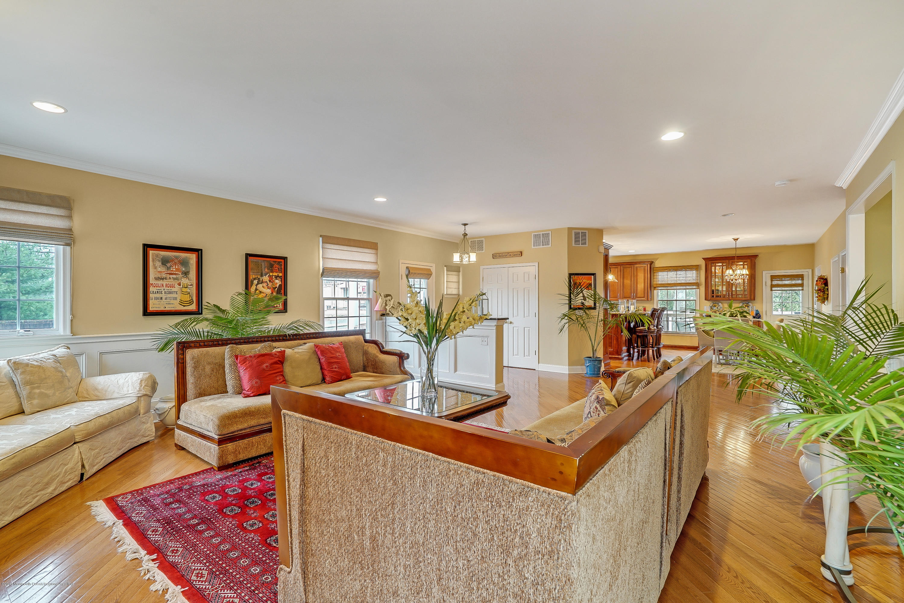 a dining room with furniture and wooden floor