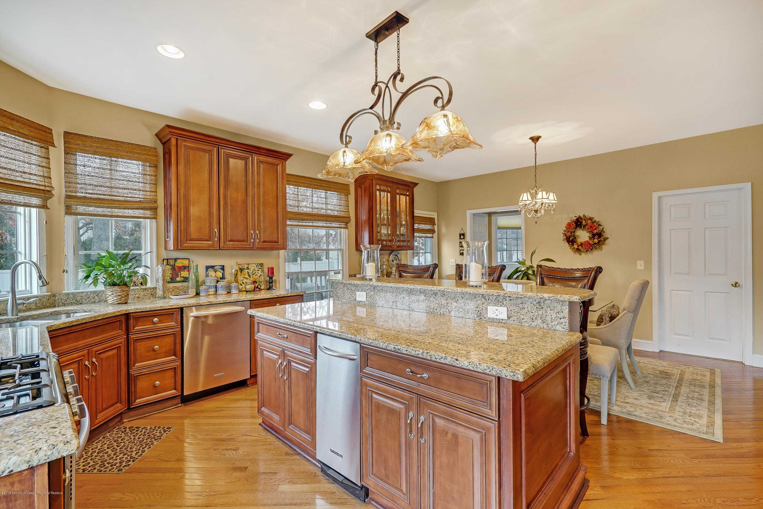 18 Mariners Bend Brielle, NJ 08730 - Photo 12 of 30 a kitchen with stainless steel appliances granite countertop a sink a stove and a wooden cabinets