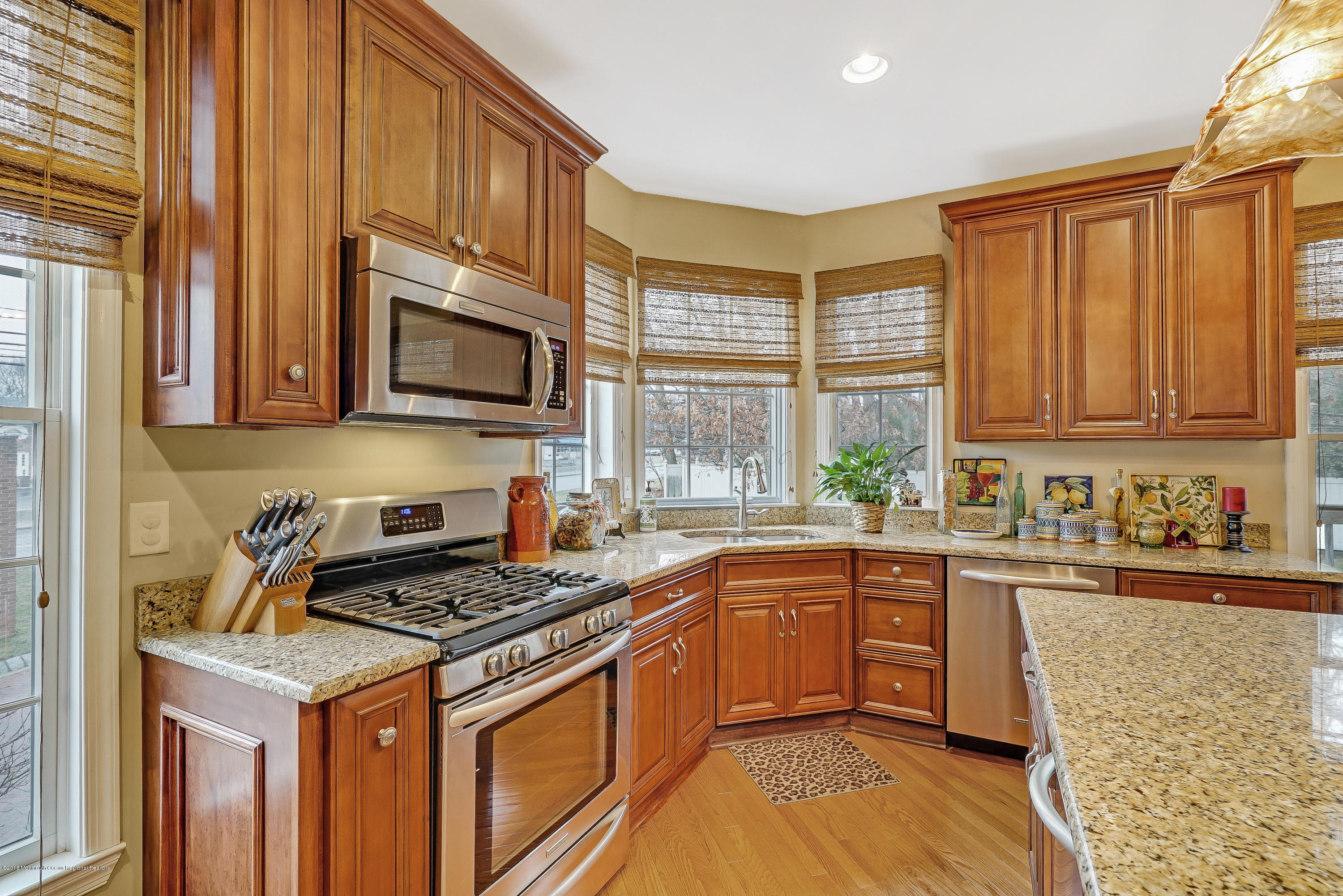 18 Mariners Bend Brielle, NJ 08730 - Photo 13 of 30 a kitchen with stainless steel appliances granite countertop a stove a sink dishwasher and a microwave oven with cabinets
