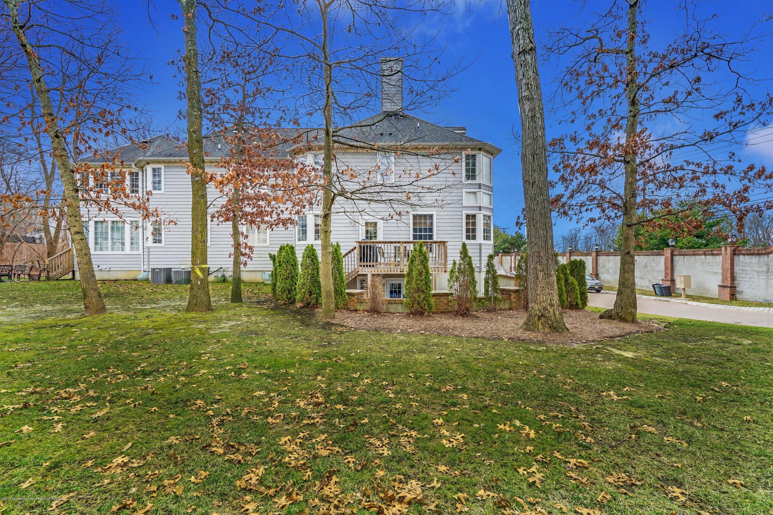 18 Mariners Bend Brielle, NJ 08730 - Photo 27 of 30 a view of a large house with a big yard and large trees