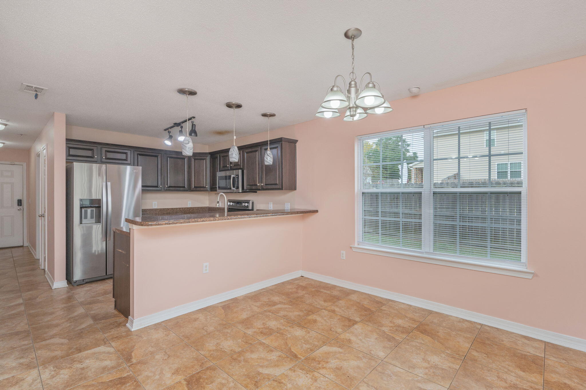 200 Wainwright Drive Crestview, FL 32539 - Photo 11 of 44 a view of a kitchen with refrigerator and windows