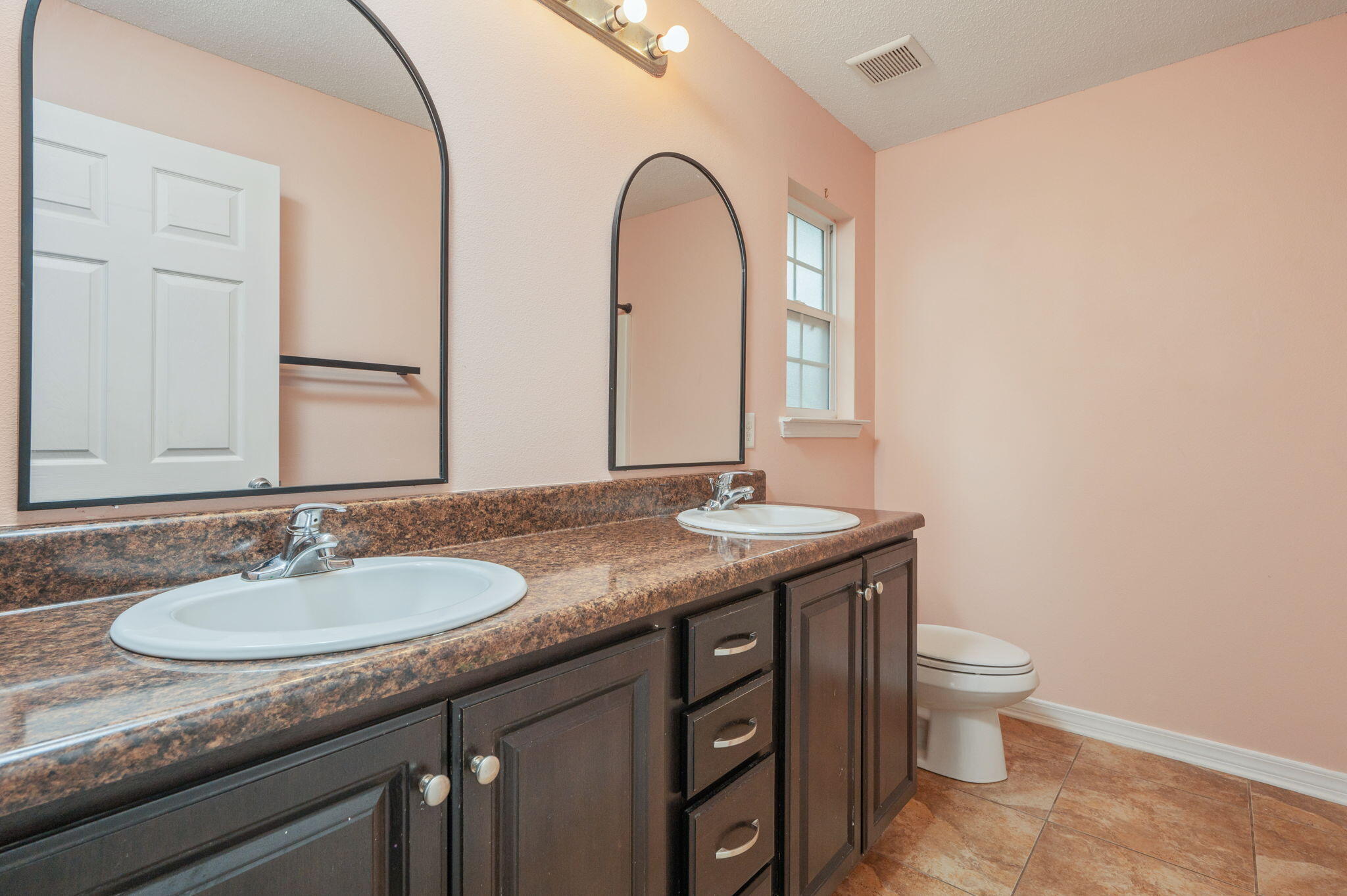 200 Wainwright Drive Crestview, FL 32539 - Photo 15 of 42 a bathroom with a granite countertop sink a toilet and a mirror