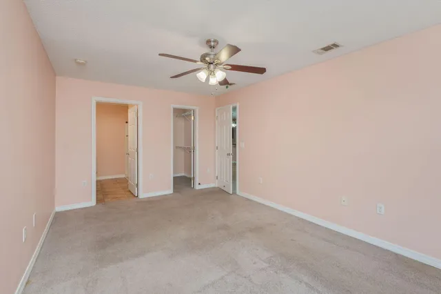 a bathroom with a granite countertop sink a toilet and a mirror