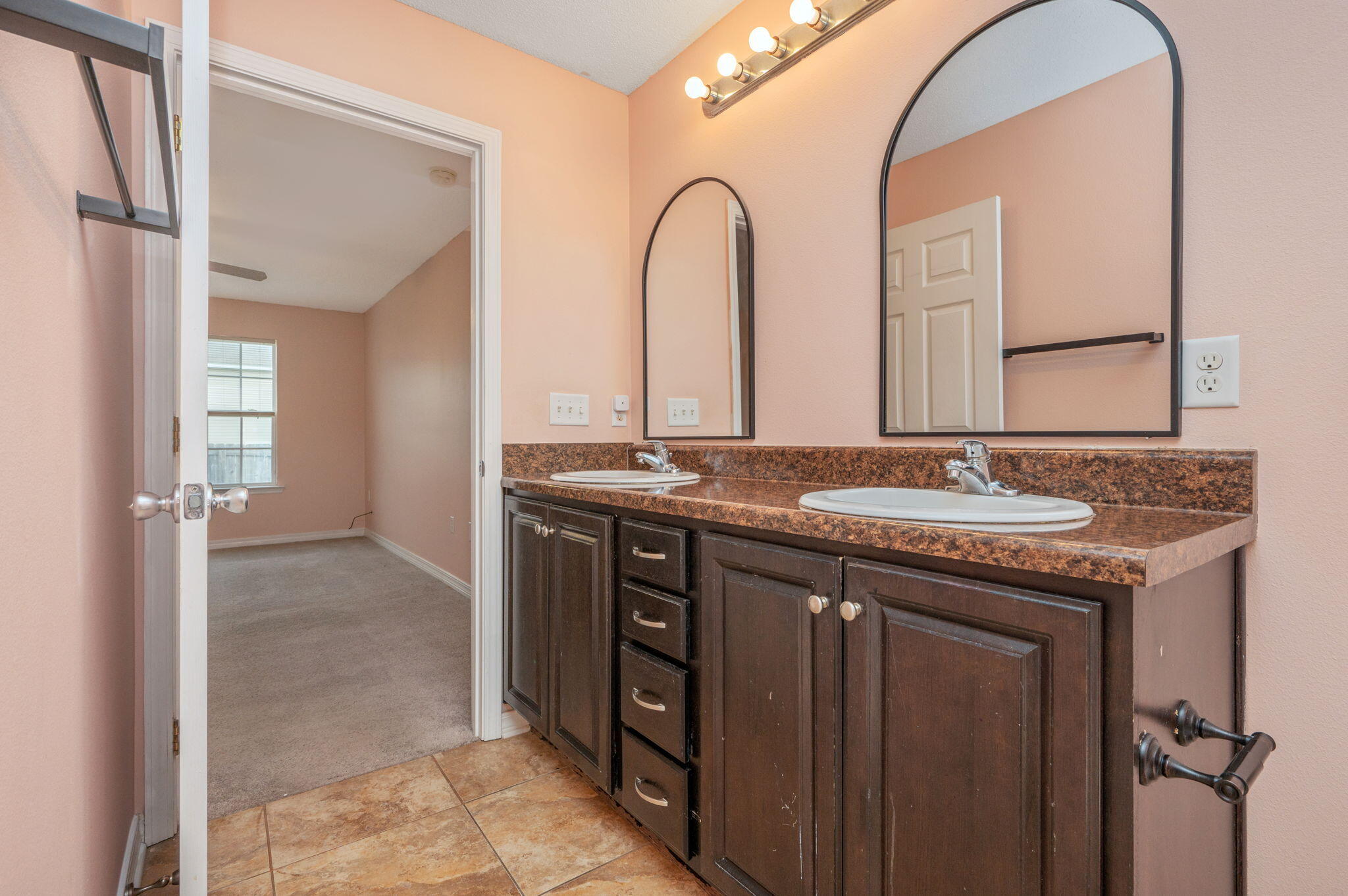 200 Wainwright Drive Crestview, FL 32539 - Photo 18 of 44 a bathroom with a granite countertop sink two mirror and a vanity