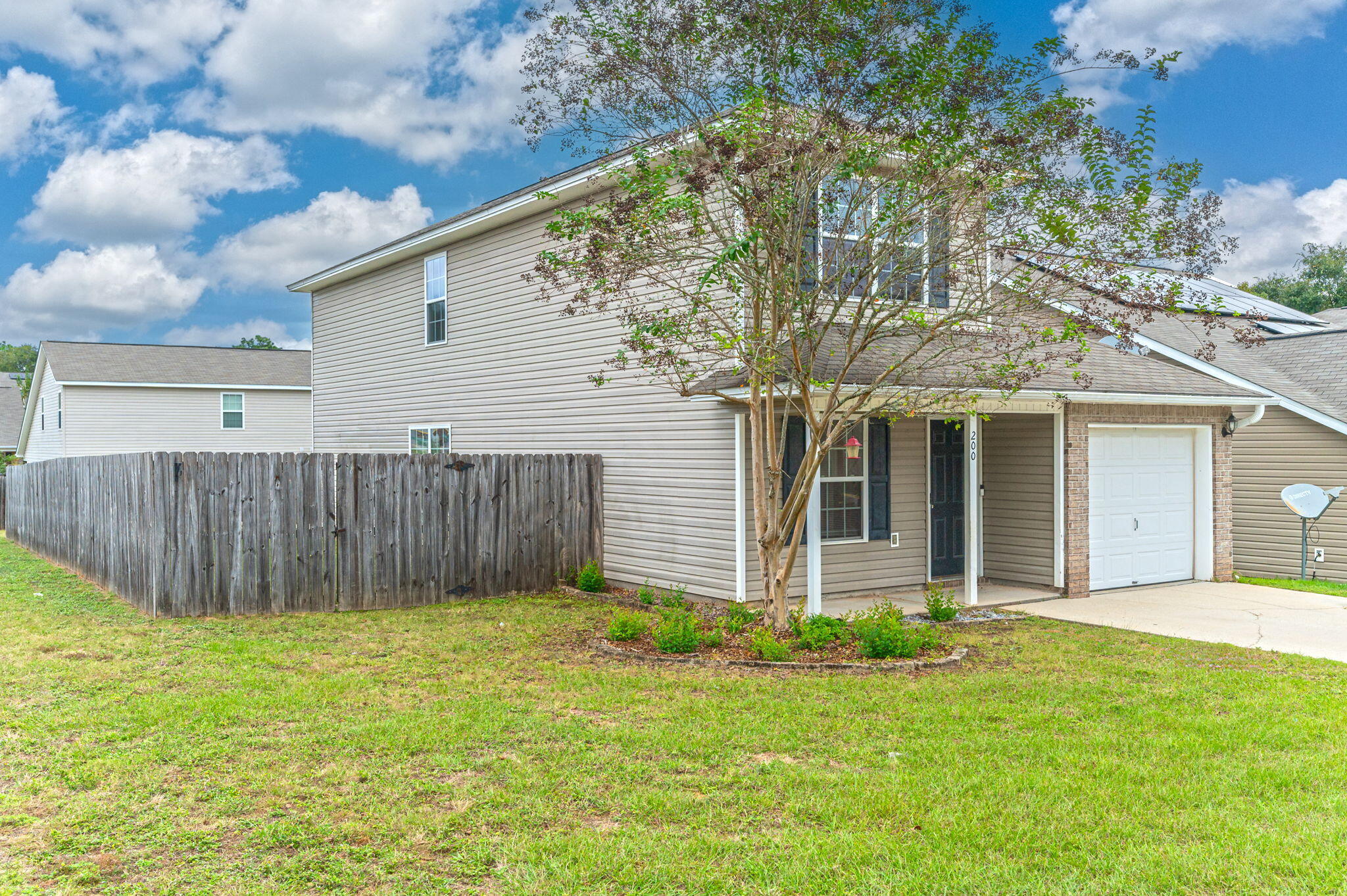 200 Wainwright Drive Crestview, FL 32539 - Photo 2 of 44 a front view of a house with a yard and fence