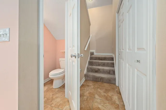 a bathroom with a toilet a sink and a mirror