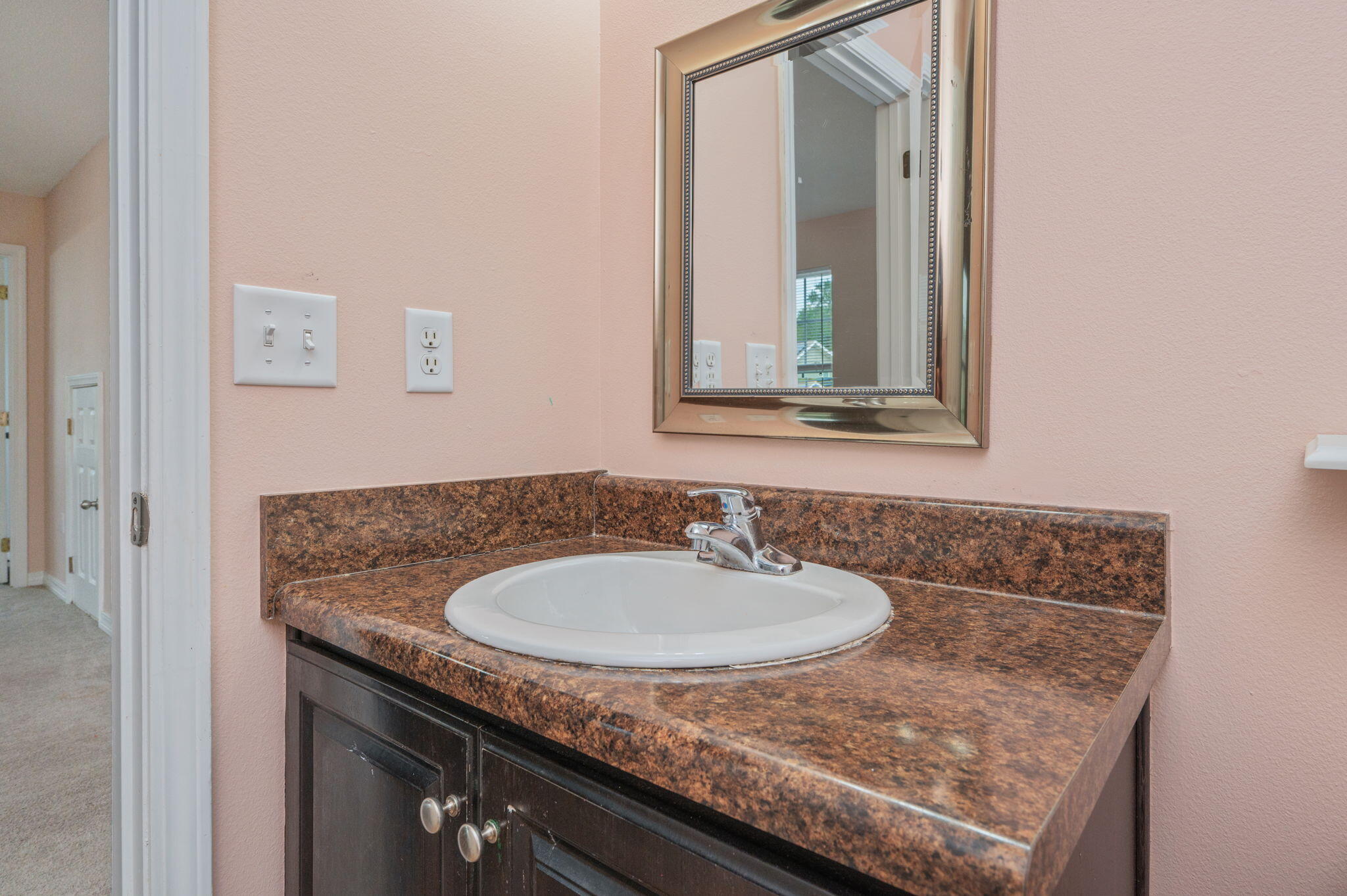 200 Wainwright Drive Crestview, FL 32539 - Photo 30 of 42 a bathroom with a granite countertop sink and a mirror