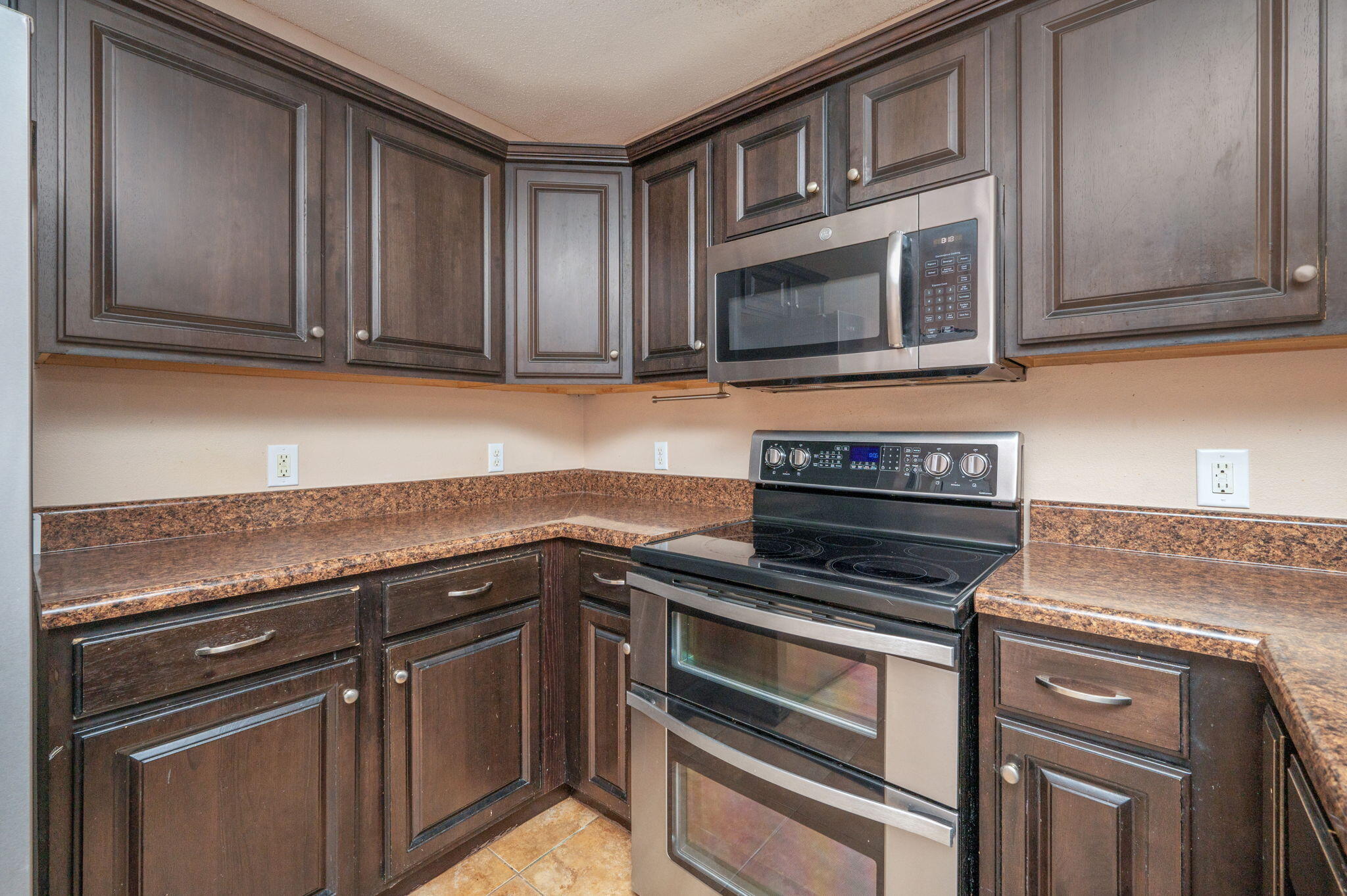 200 Wainwright Drive Crestview, FL 32539 - Photo 7 of 42 a kitchen with granite countertop cabinets stainless steel appliances and wooden cabinets