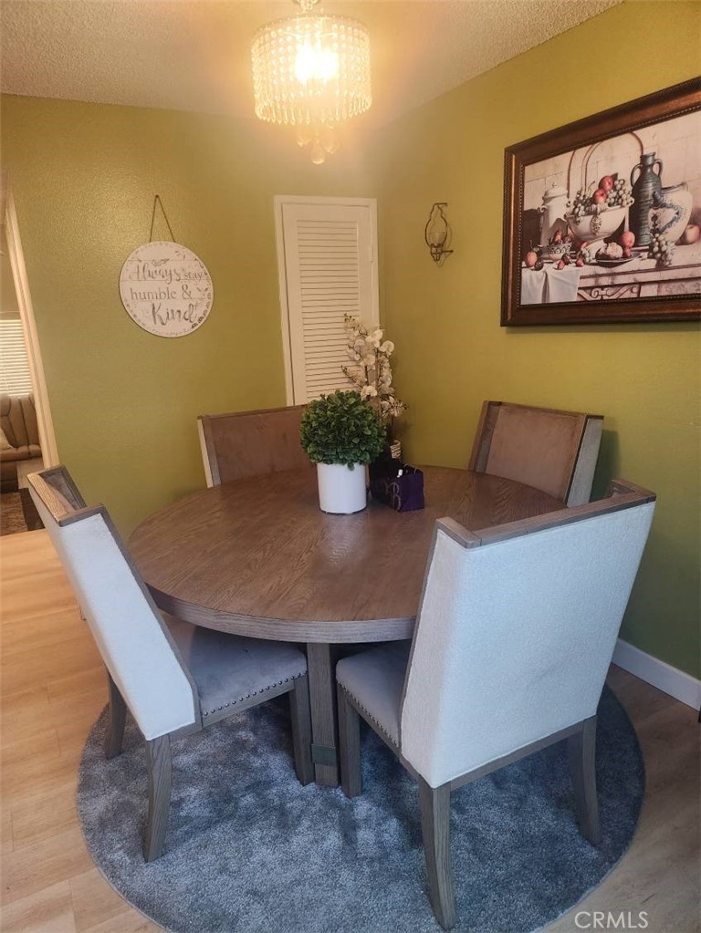 21730 Grace Avenue, Unit 2 Carson, CA 90745 - Photo 12 of 36 a view of a dining room with furniture and wooden floor