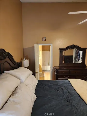 a bedroom with a bed and dresser