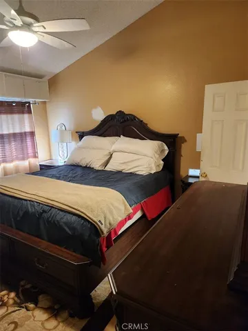 a bedroom with a bed and lamp