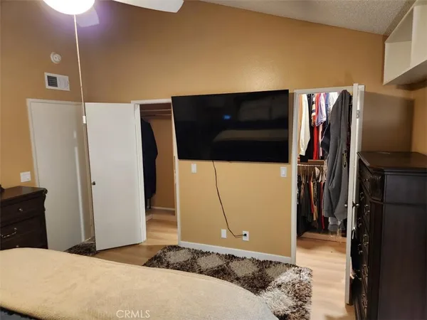 a bedroom with a bed and a television
