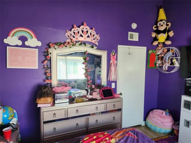 a bedroom with a bed and a dresser