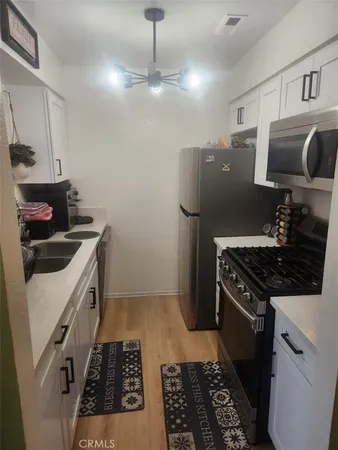 a kitchen with a stove and a refrigerator