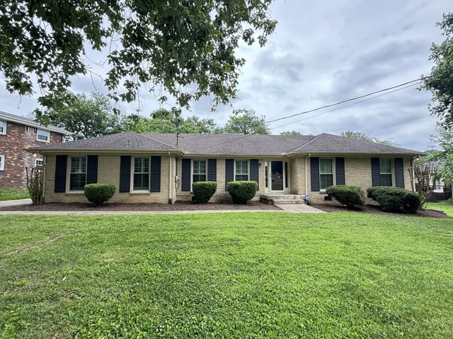 a front view of a house with a garden and porch