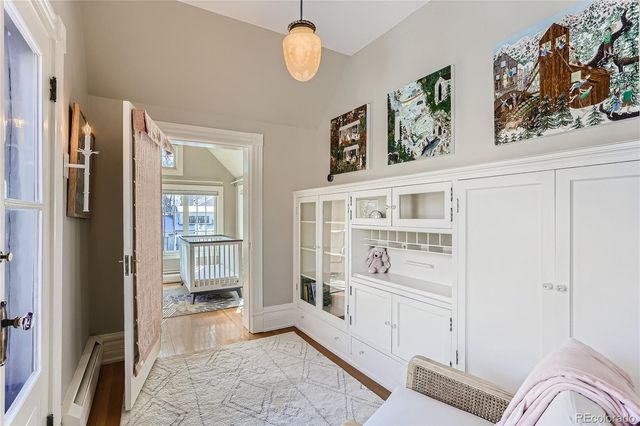 a view of a hallway with cabinet and a living room