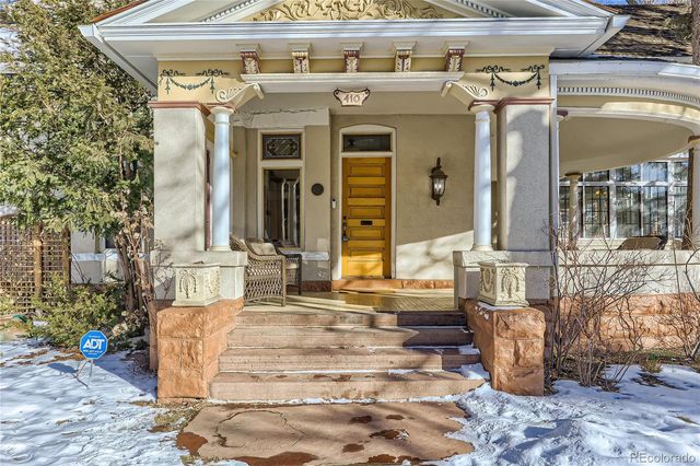 a front view of a house with outdoor seating