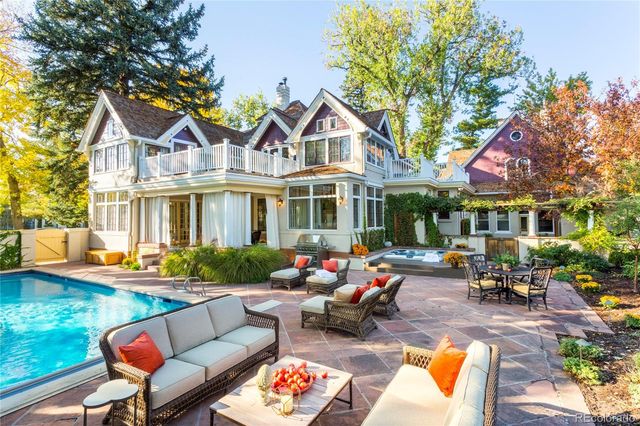 a view of a house with swimming pool and sitting area