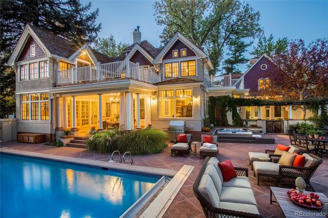 a view of a house with swimming pool and sitting area