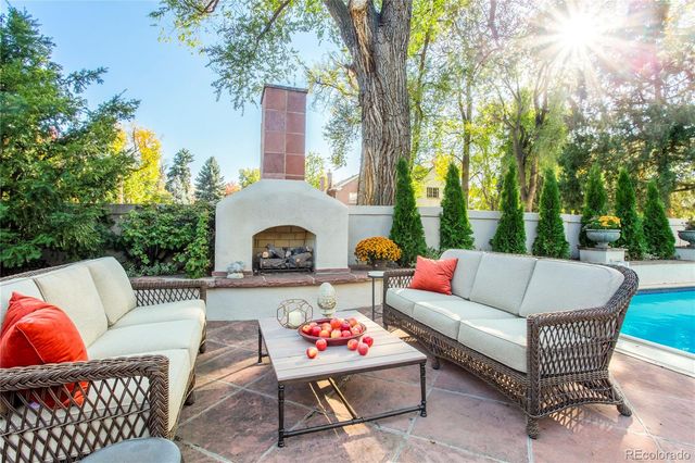 a outdoor living space with furniture and a fireplace