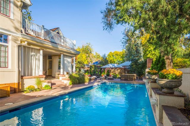 a view of a house with swimming pool and sitting area