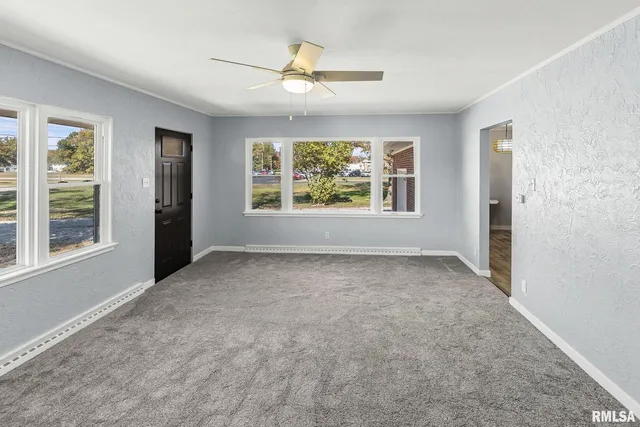 an empty room with windows and closet
