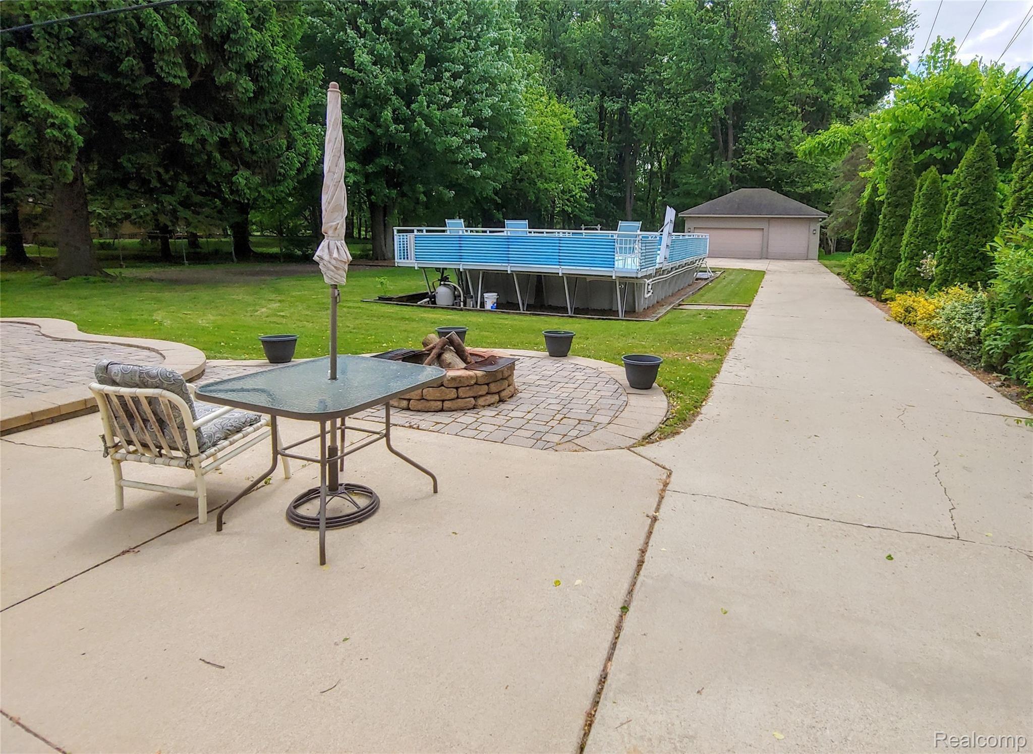 21109 Northline Road Taylor, MI 48180 - Photo 27 of 34 Park like setting - patio - fire pit - above ground pool - huge yard - lots of trees