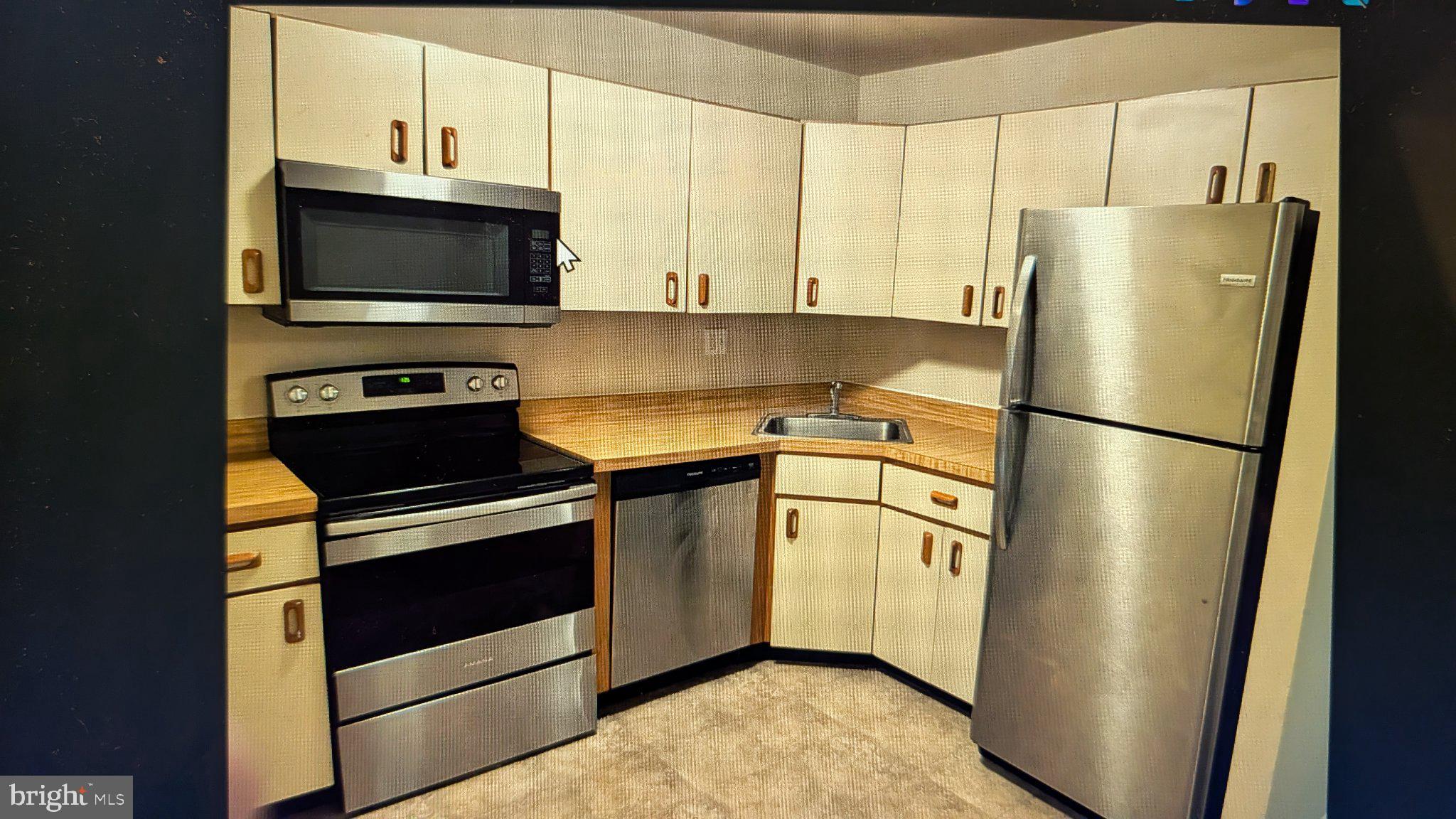 1204 Huntingdon Mews Clementon, NJ 08021 - Photo 3 of 10 a kitchen with stainless steel appliances granite countertop a refrigerator stove and microwave
