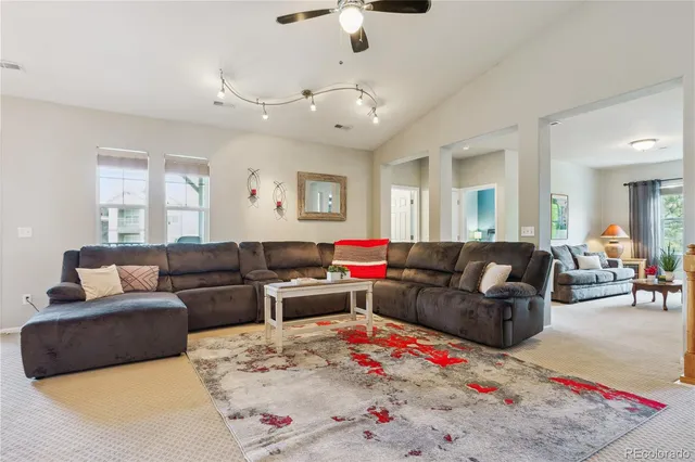 a living room with furniture and a chandelier