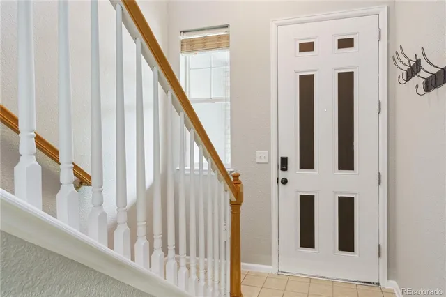 a view of staircase with lots of frames on wall and stairs