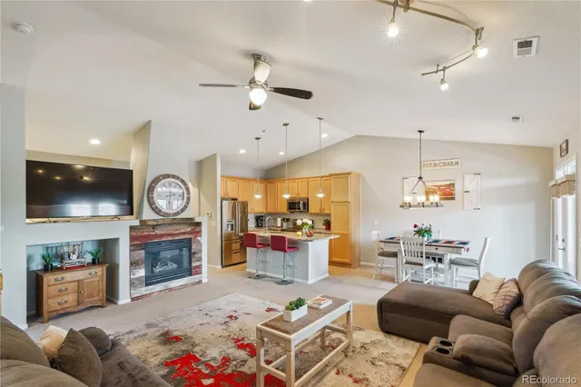a living room with fireplace furniture and a flat screen tv