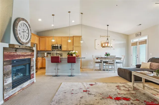 a living room with furniture a clock and a fireplace