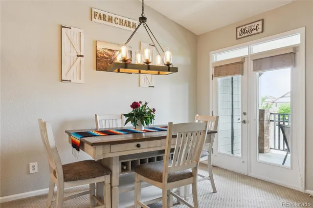 a view of a dining room with furniture and chandelier