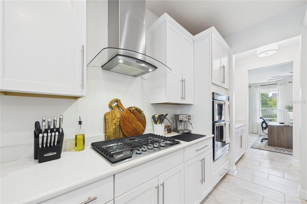 458 Convex Lane St. Augustine, FL 32095 - Photo 13 of 60 a kitchen with white cabinets and appliances