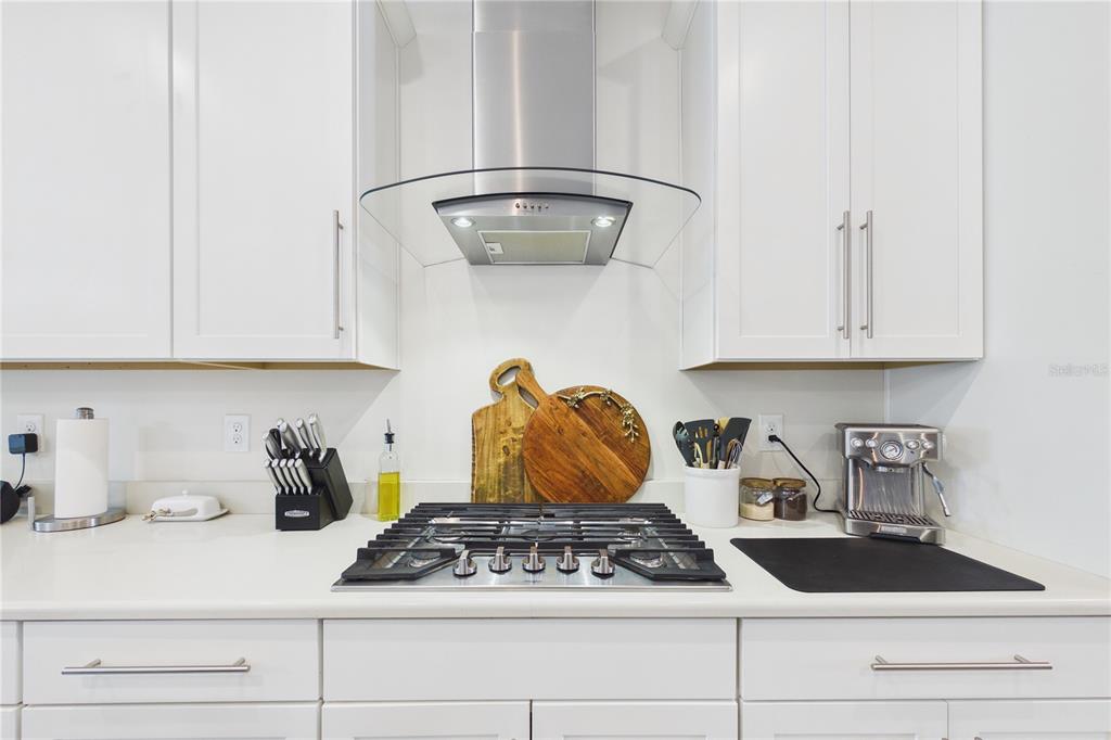 458 Convex Lane St. Augustine, FL 32095 - Photo 15 of 60 a kitchen with white cabinets and a stove