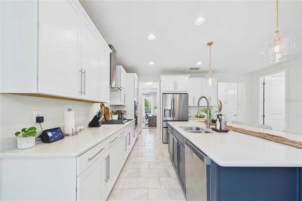 458 Convex Lane St. Augustine, FL 32095 - Photo 17 of 60 a large kitchen with kitchen island a sink stove and cabinets