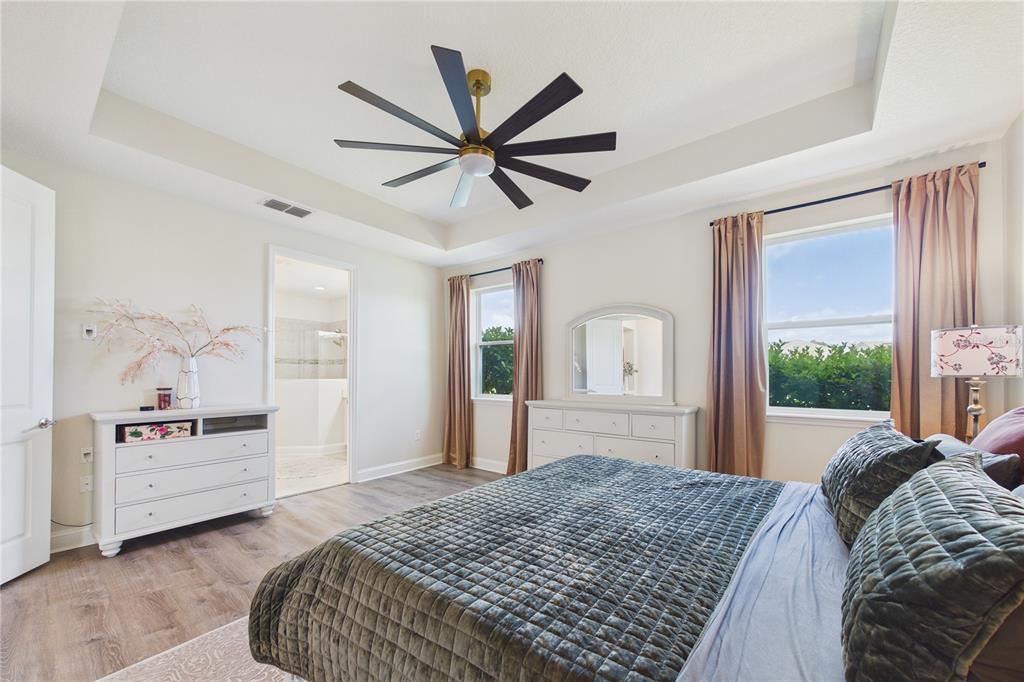 458 Convex Lane St. Augustine, FL 32095 - Photo 25 of 60 a bedroom with a large bed and a chandelier