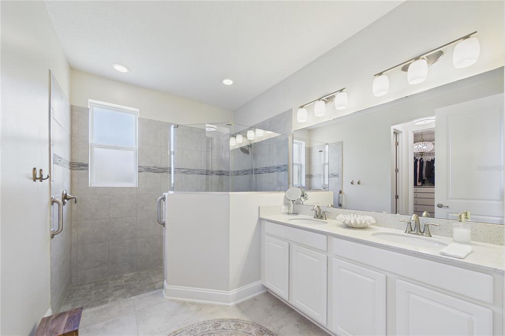 458 Convex Lane St. Augustine, FL 32095 - Photo 26 of 60 a bathroom with a double vanity sink mirror and shower
